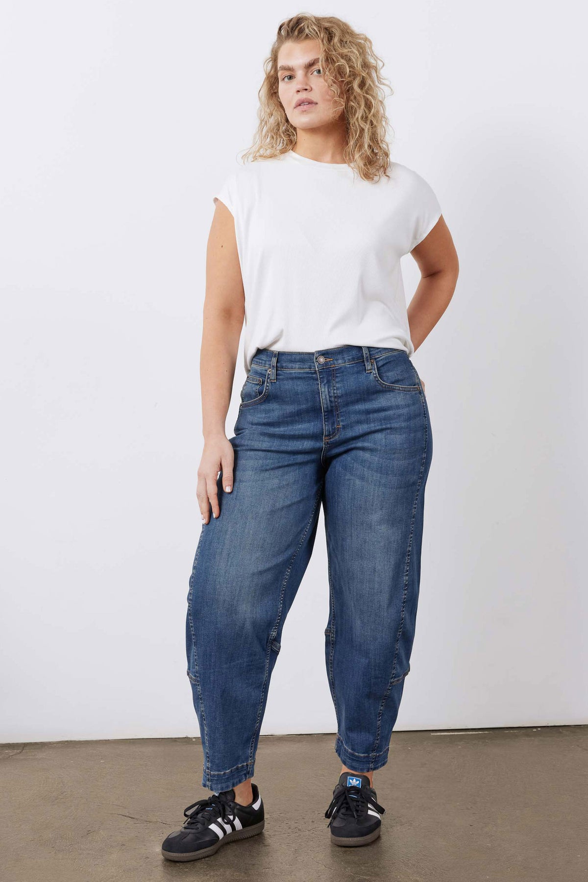Indigo barrel-leg jeans with belt loops, front pockets, and cuffed ankle hem