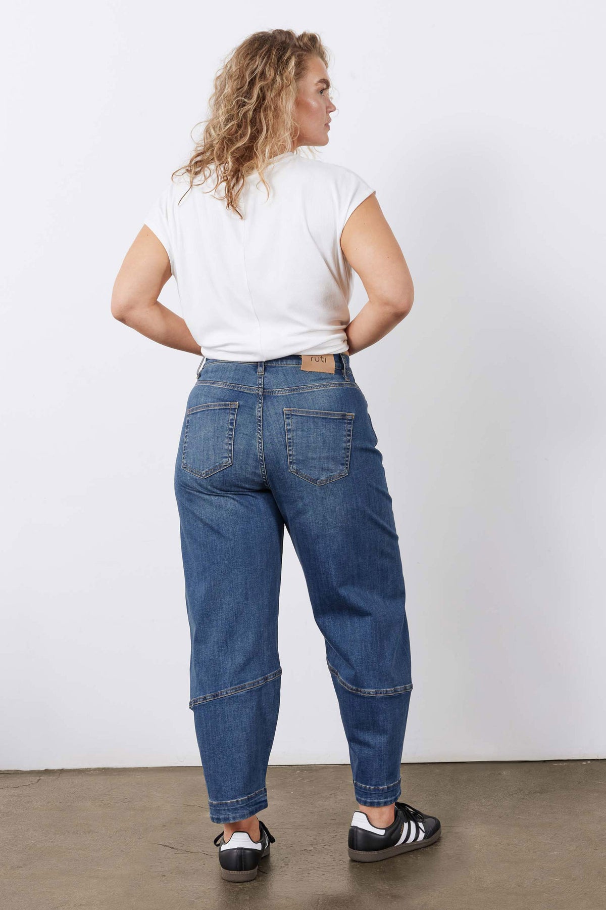 Indigo barrel-leg jeans with back yoke, pockets, and cuffed hem