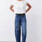 Indigo barrel-leg jeans with mid-rise fit, belt loops, and button-front closure