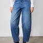 Indigo barrel-leg jeans front view with contrast topstitching and belt