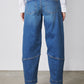 Indigo barrel-leg jeans rear view with yoke seam details and cuffed hems