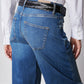 Indigo barrel-leg jeans close-up of waistband, braided belt, and hip pocket