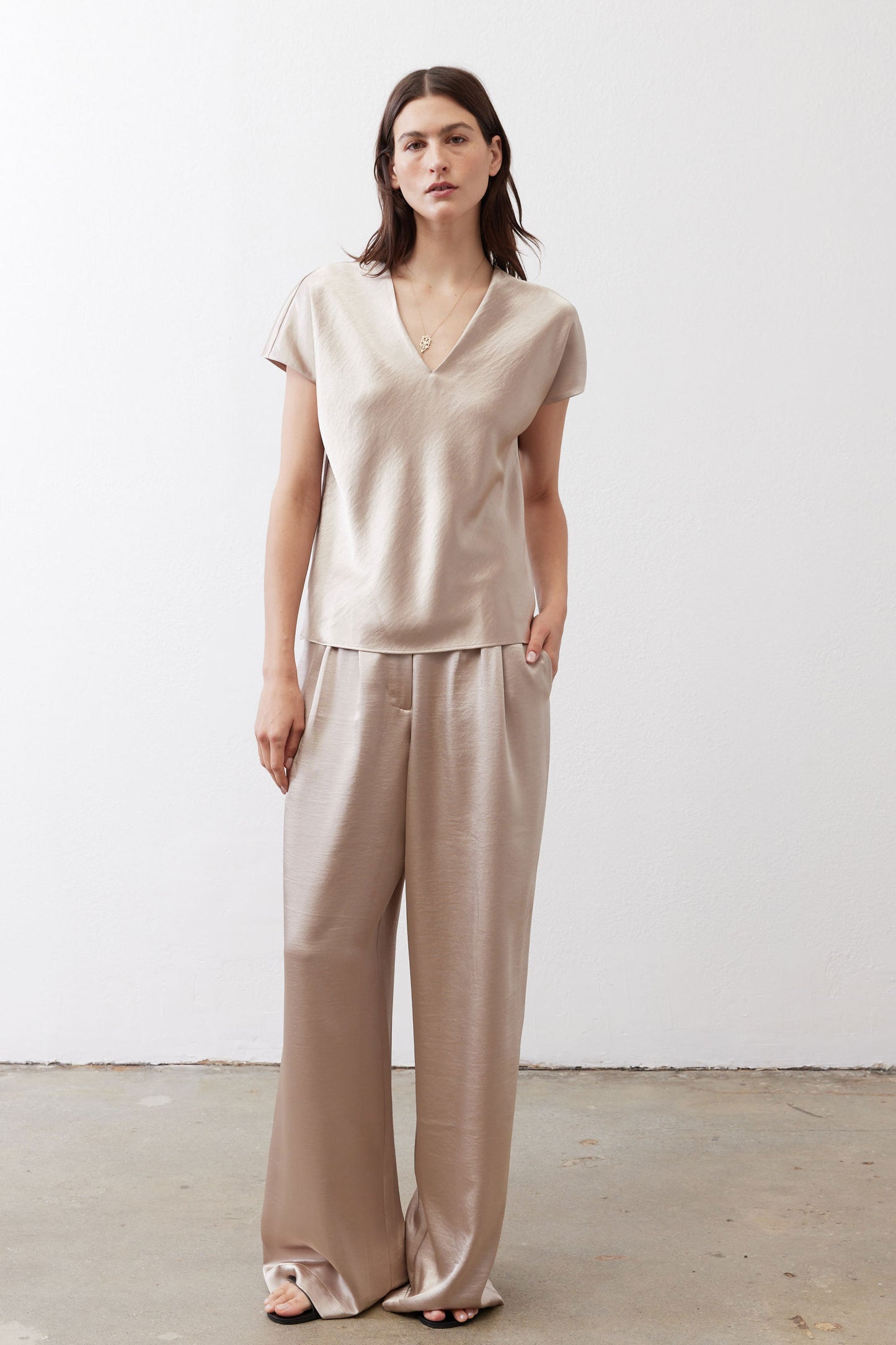 Champagne V-neck short-sleeve top with relaxed fit and draped neckline