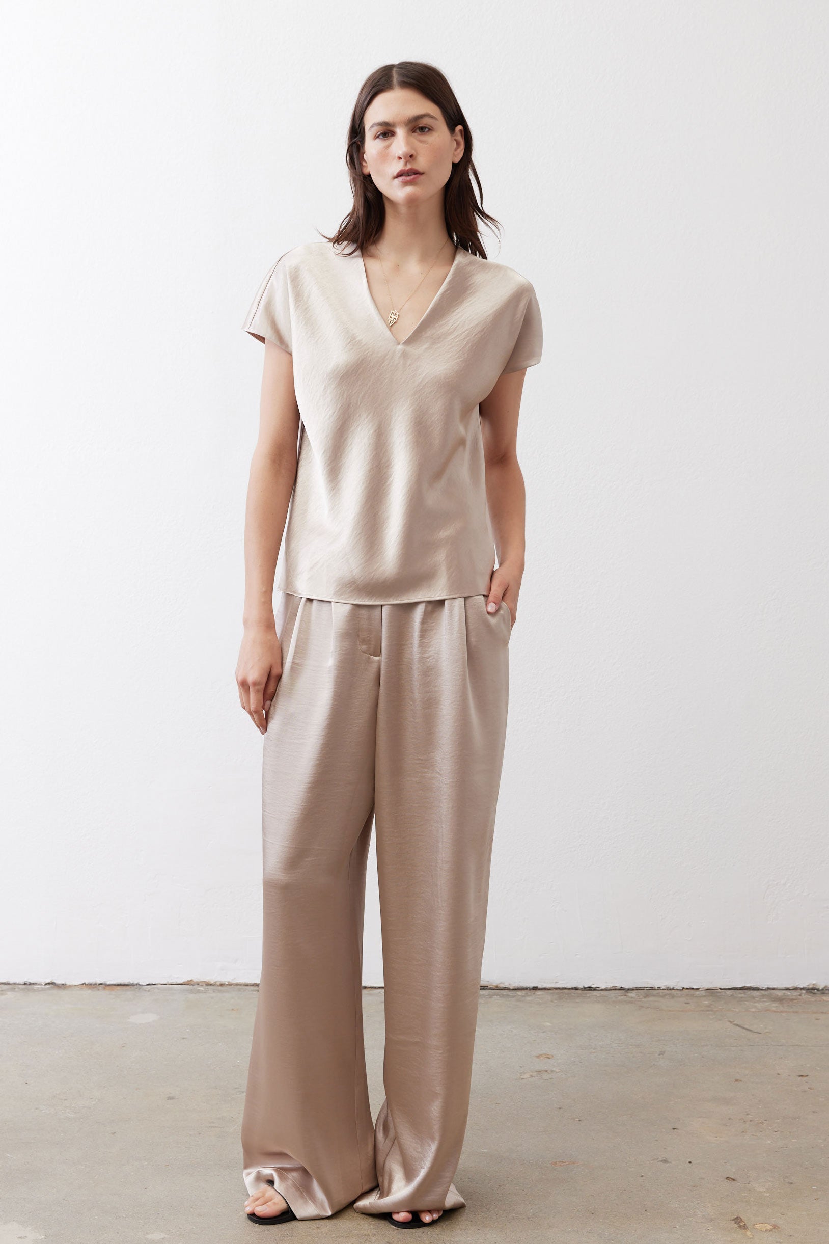 Champagne V-neck short-sleeve top with relaxed fit and draped neckline