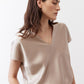 Champagne V-neck short-sleeve top with draped neckline and relaxed fit