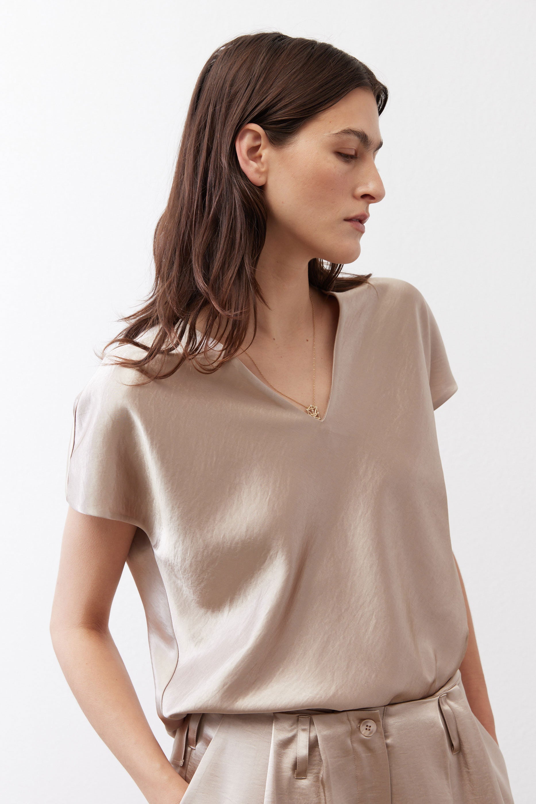 Champagne V-neck short-sleeve top with draped neckline and relaxed fit