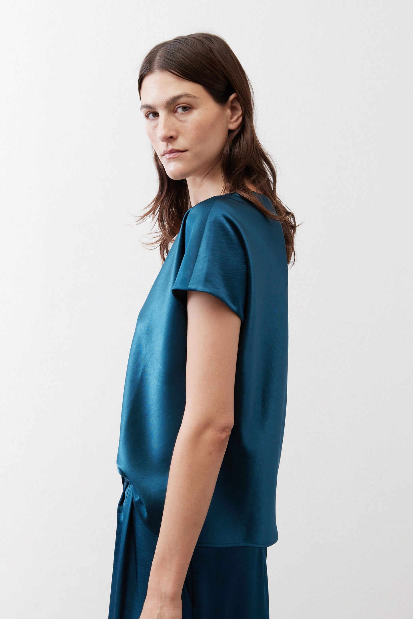 Deep teal V-neck short-sleeve top, relaxed side view