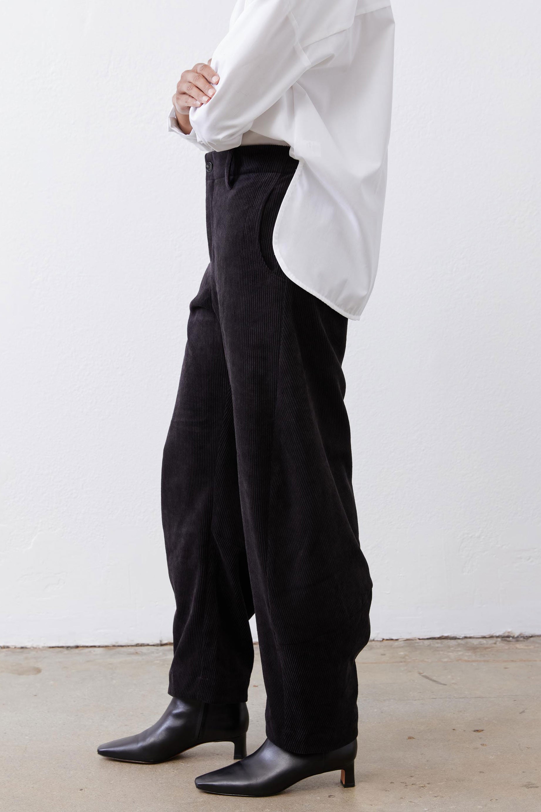 Black loose barrel corduroy pants with roomy fit and ankle-length hem