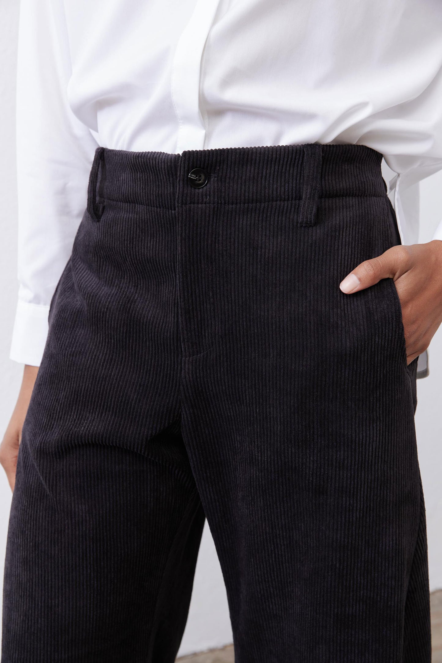 Black corduroy pants with button front and wide straight barrel legs