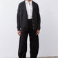 Black corduroy barrel pants with gathered waist and relaxed wide-leg silhouette