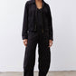 Black corduroy barrel pants with button front, high rise, and roomy legs