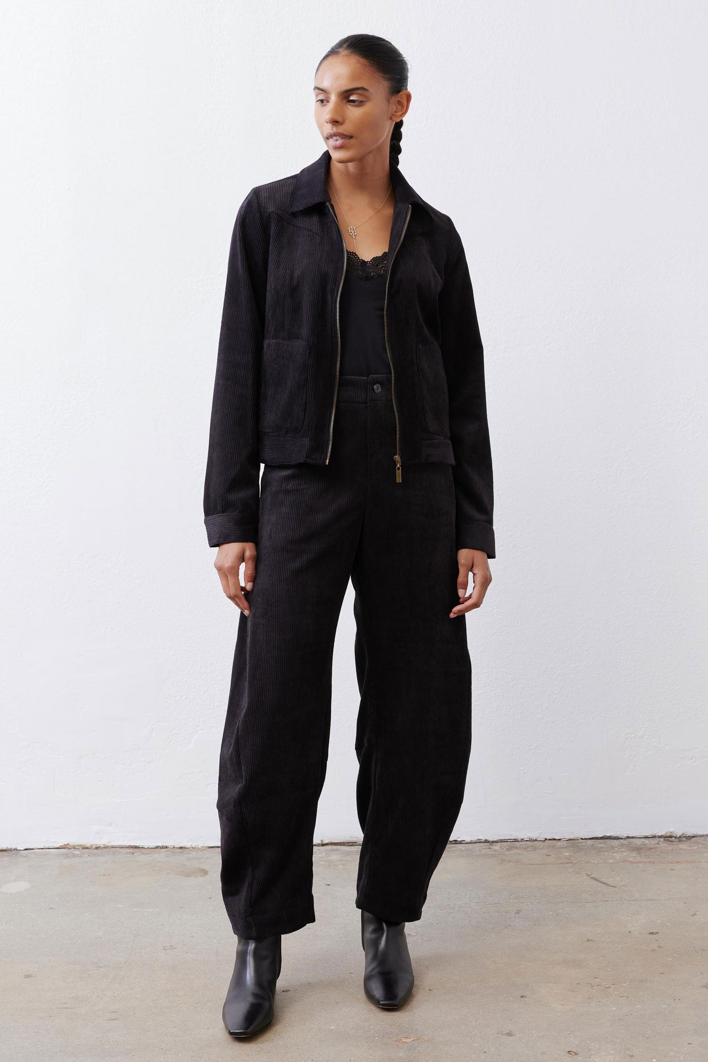 Black corduroy barrel pants with button front, high rise, and roomy legs