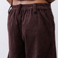 Chocolate-plum corduroy pants close-up, ribbed texture and gathered elastic waist