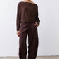 Chocolate-plum corduroy barrel pants on model, loose fit with cropped-ankle hem