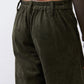 Dark green corduroy barrel pants close-up: gathered elastic waistband detail