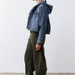 Dark green loose corduroy barrel pants from the side, wide leg opening