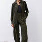 Dark green corduroy barrel pants with wide legs and elastic waist, full length