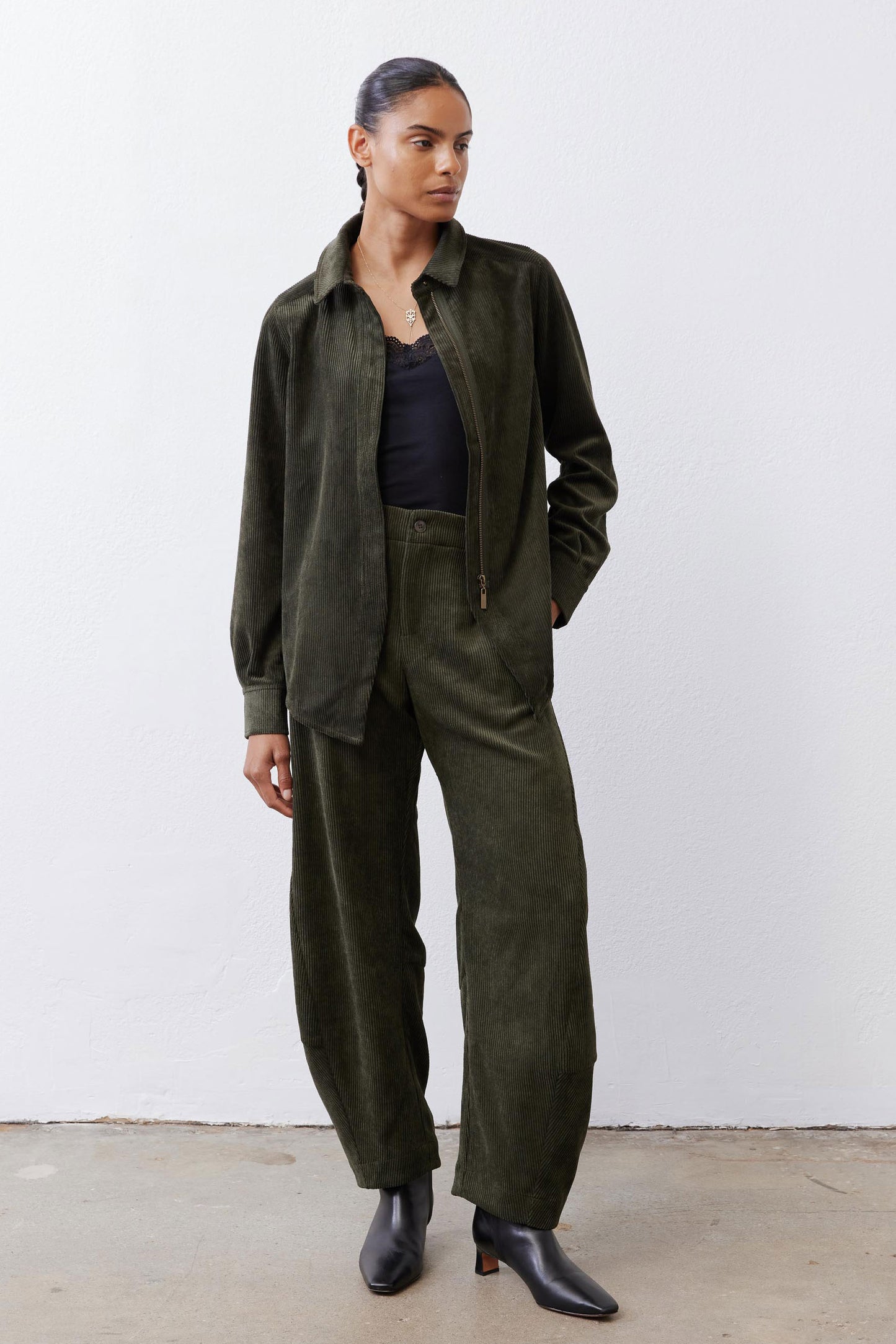 Dark green corduroy barrel pants with wide legs and elastic waist, full length