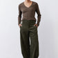 Dark green loose corduroy barrel pants with elastic waist and wide, draped legs