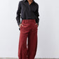 Pomegranate corduroy barrel pants showing button closure and roomy rise