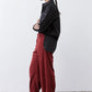 Pomegranate corduroy barrel pants in side profile with full-length relaxed leg