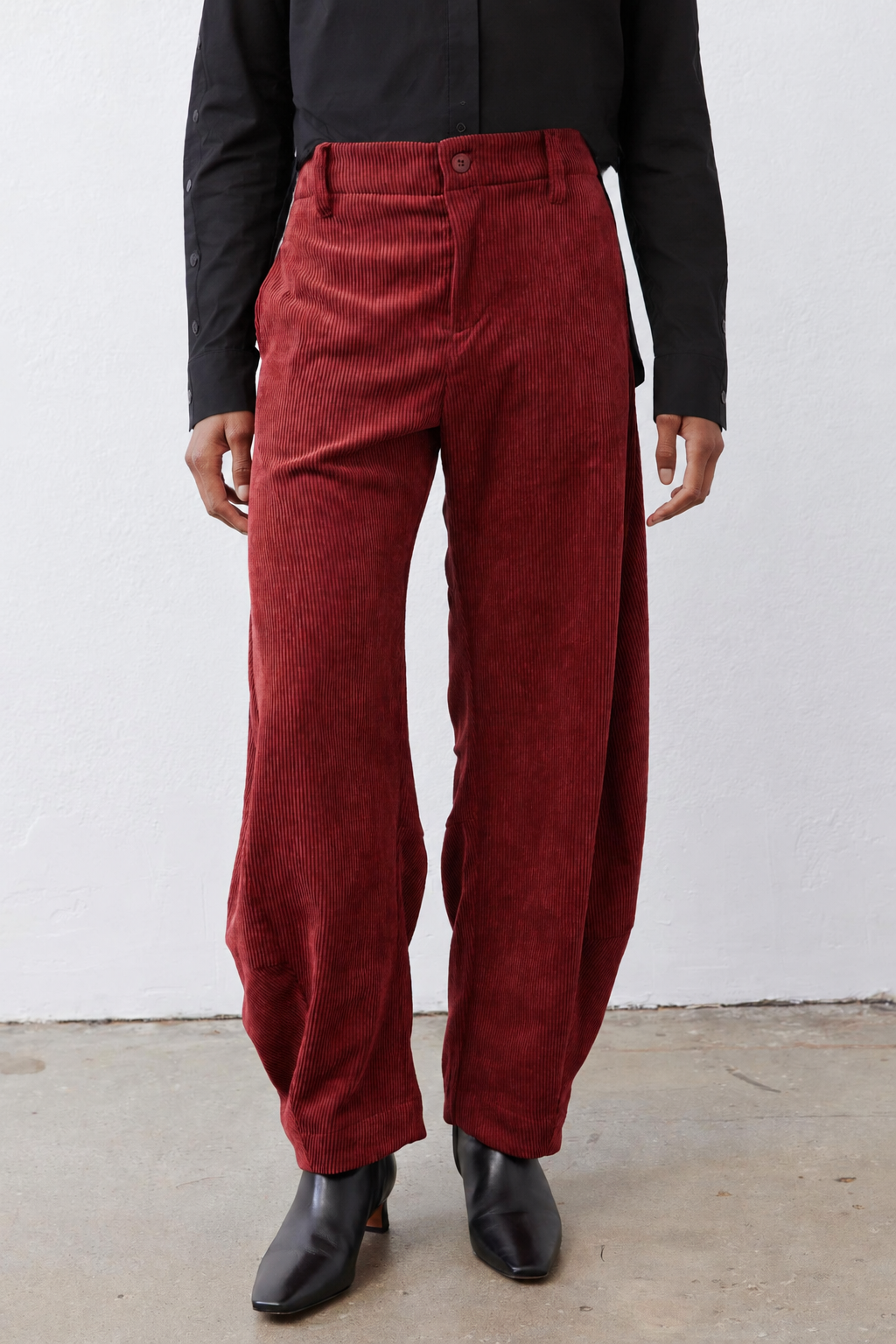 Pomegranate corduroy barrel pants front view with belt loops and pleated details