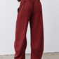 Pomegranate corduroy barrel pants rear view with gathered waistband and relaxed leg