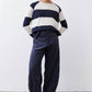 Dark navy loose corduroy barrel pants with elastic waistband and cropped ankle