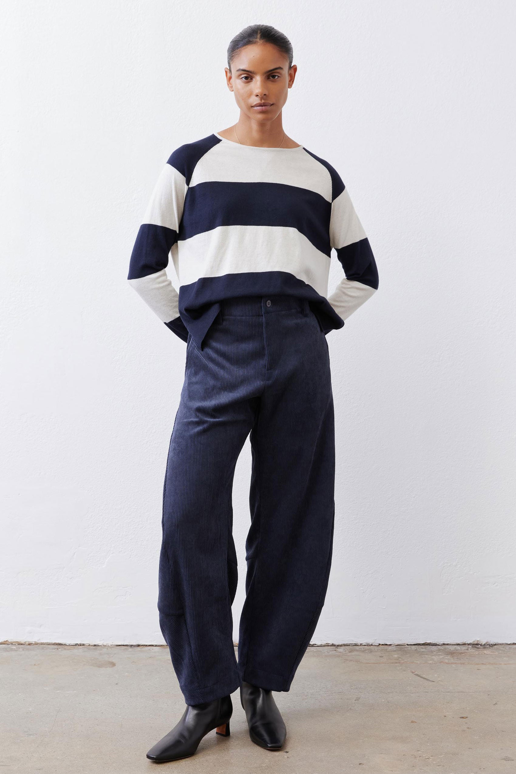 Dark navy loose corduroy barrel pants with elastic waistband and cropped ankle