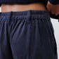 Dark navy corduroy fabric pants with elastic waistband and vertical rib texture