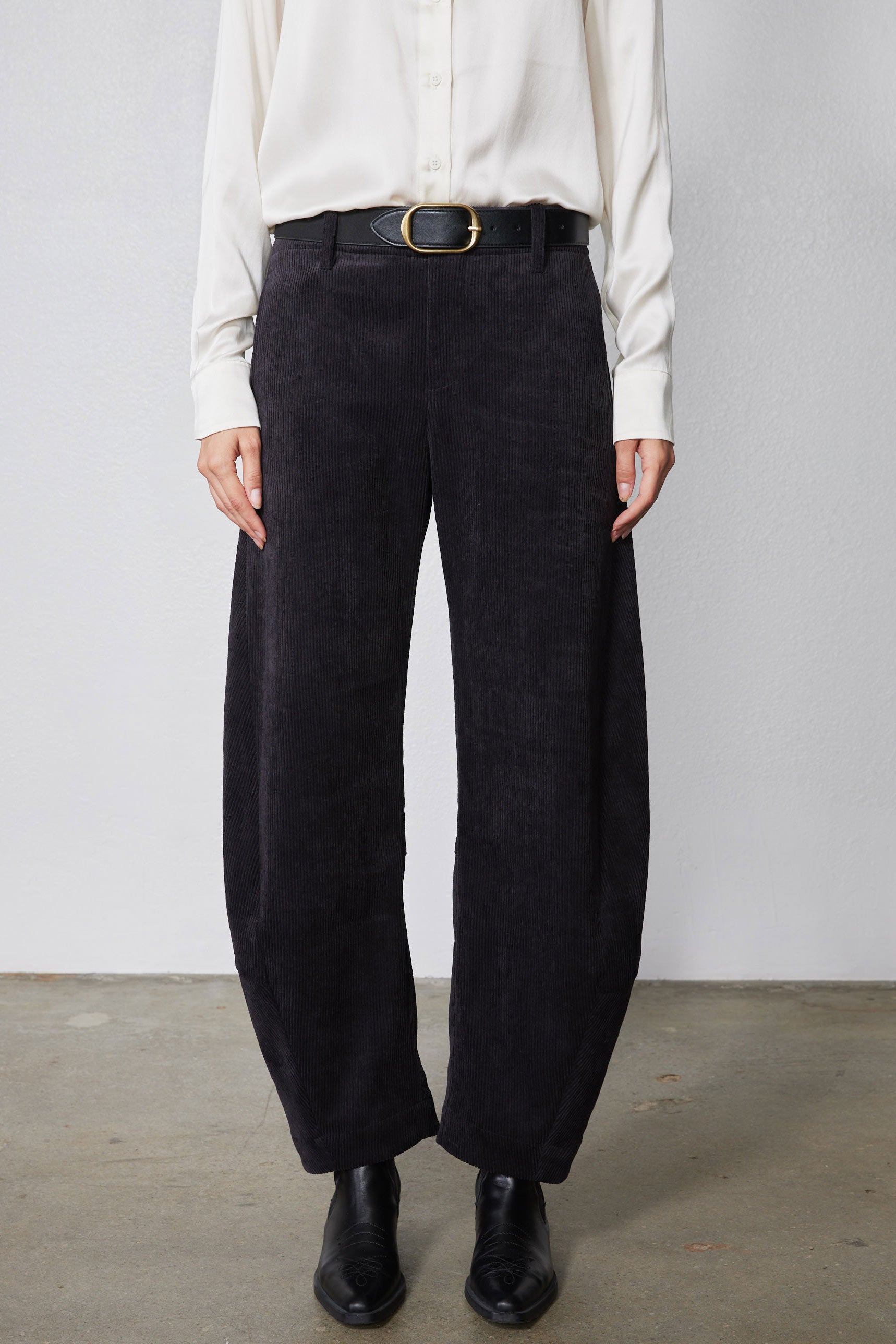 Black corduroy pants with belt loops, button fly, and wide leg opening