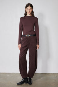 Chocolate-plum corduroy barrel pants on model, high waist with belt loops and straight legs