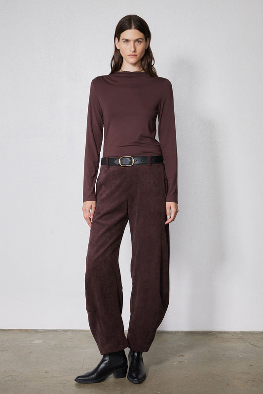 Chocolate-plum corduroy barrel pants on model, high waist with belt loops and straight legs