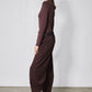 Chocolate-plum corduroy barrel pants on model, back/side view with wide leg opening
