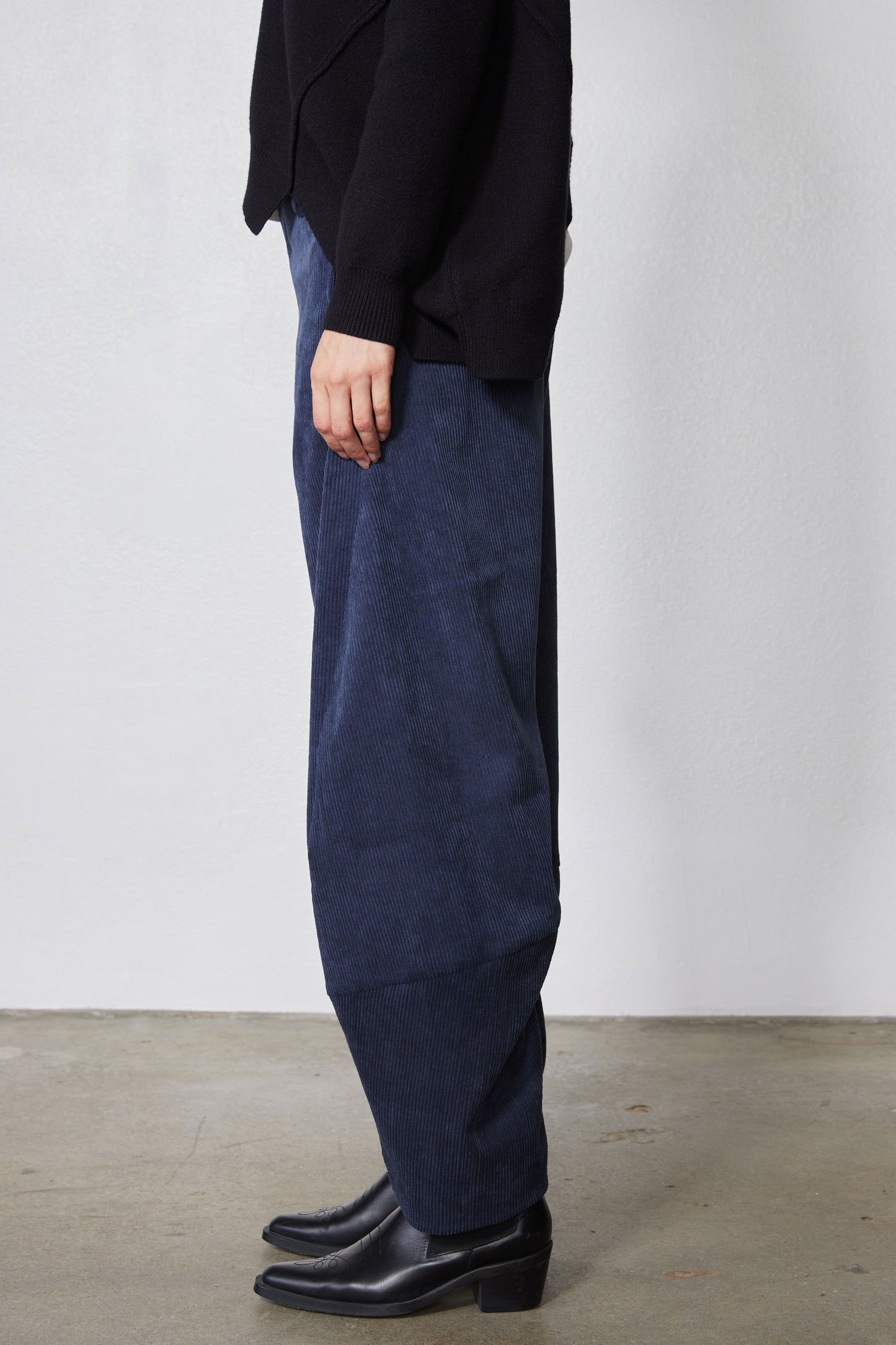 Blue corduroy pants with relaxed straight leg and roomy barrel silhouette