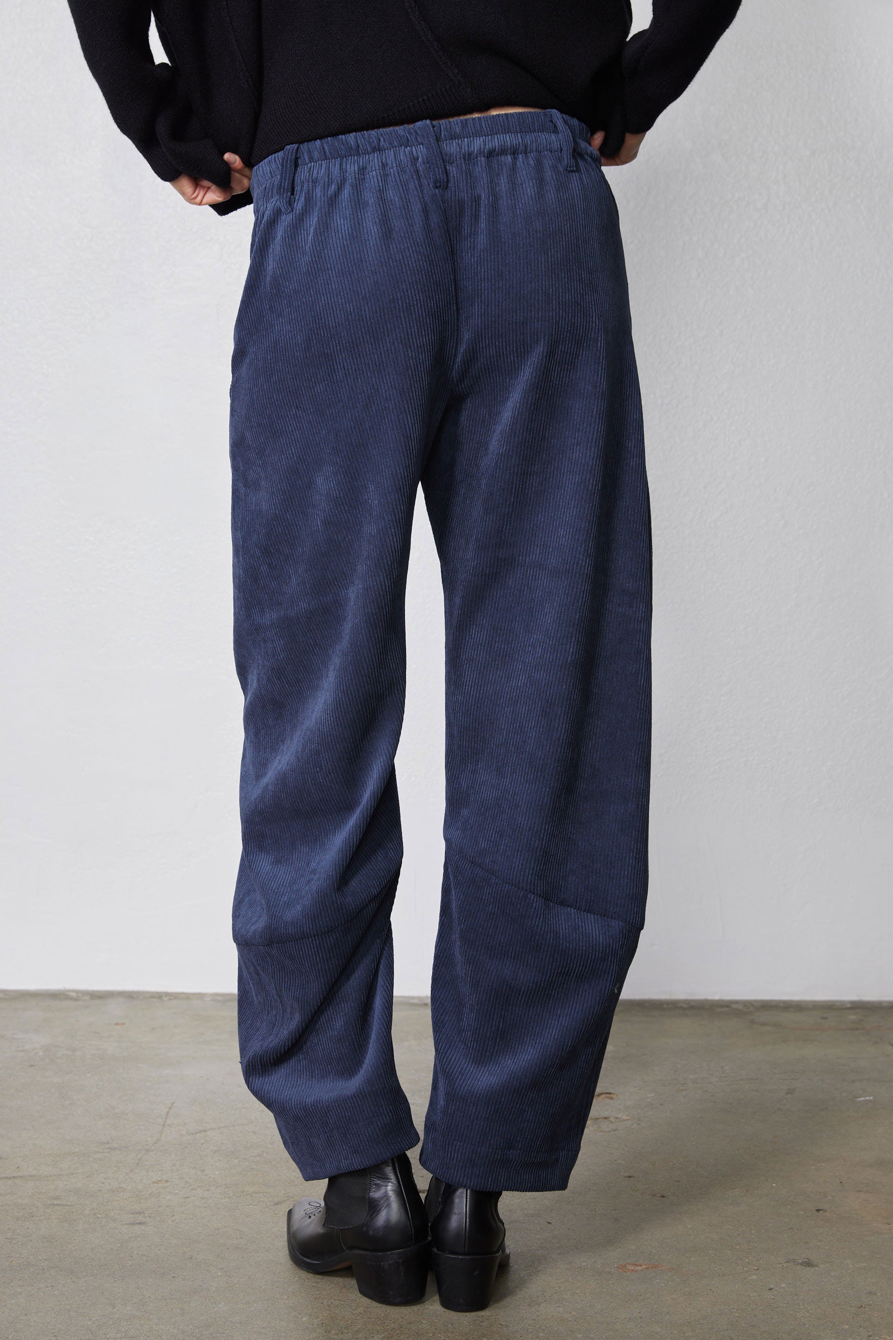 Blue corduroy pants with elastic waistband and loose barrel shape