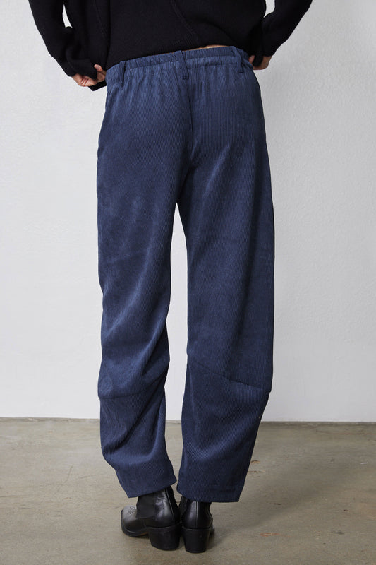 Blue corduroy pants with elastic waistband and loose barrel shape