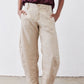 Loose linen pants in light beige with buttoned front, elastic waistband, side pockets