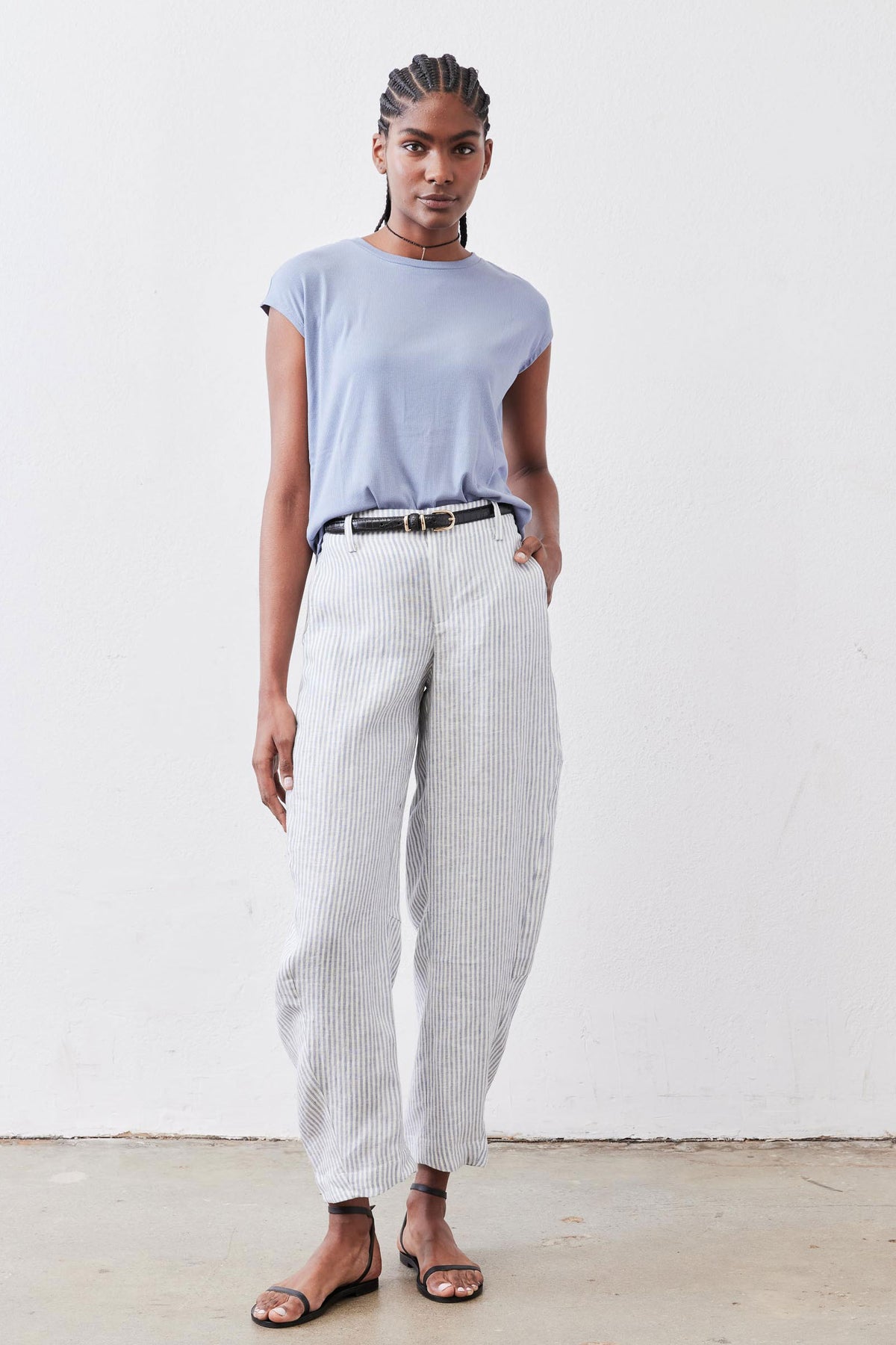 Light blue ribbed crew-neck tee with short sleeves, tucked hem