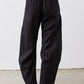 Black linen pants with elastic waistband, relaxed fit, tapered legs at ankle length