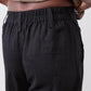 Black linen pants waistband with gathered elastic top and relaxed tapered legs