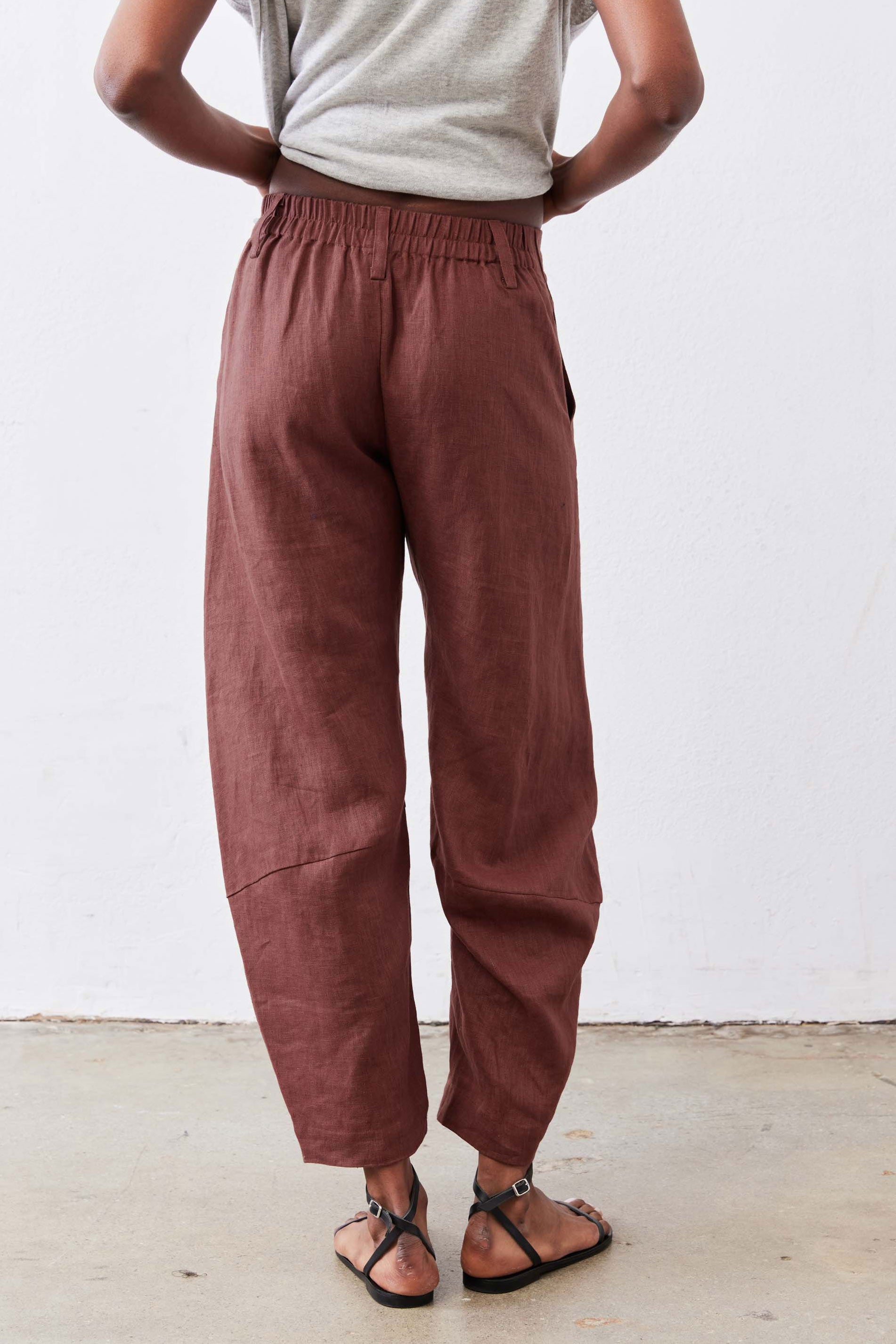 Spice brown loose linen pants with elastic waistband and cuffed ankle shape