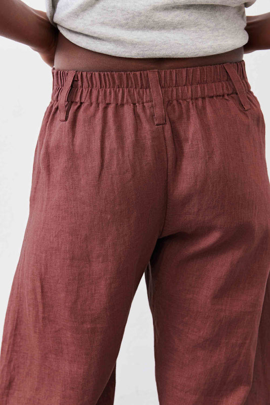 Spice brown linen pants close-up of elastic waist and front button placket