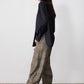 Brown plaid barrel pants, loose wide leg, side view with cuffed hem