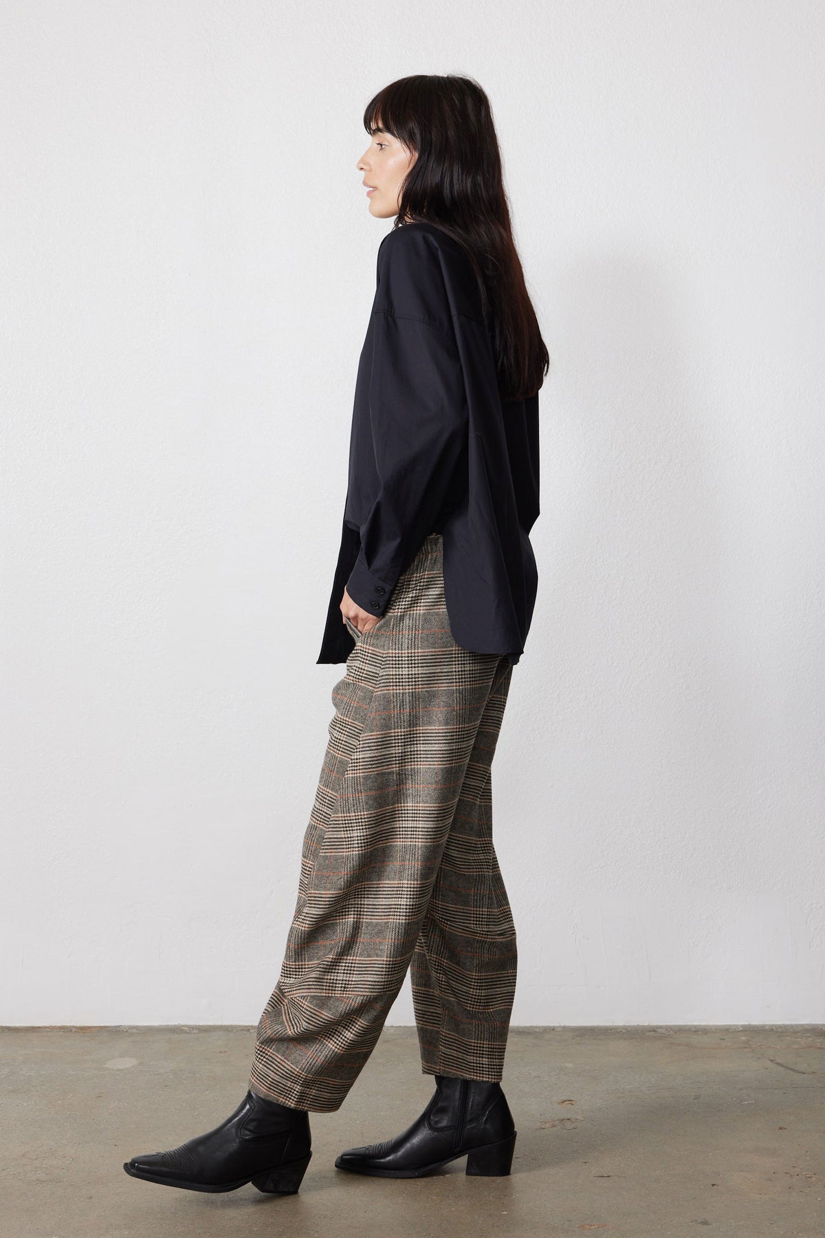 Brown plaid barrel pants, loose wide leg, side view with cuffed hem