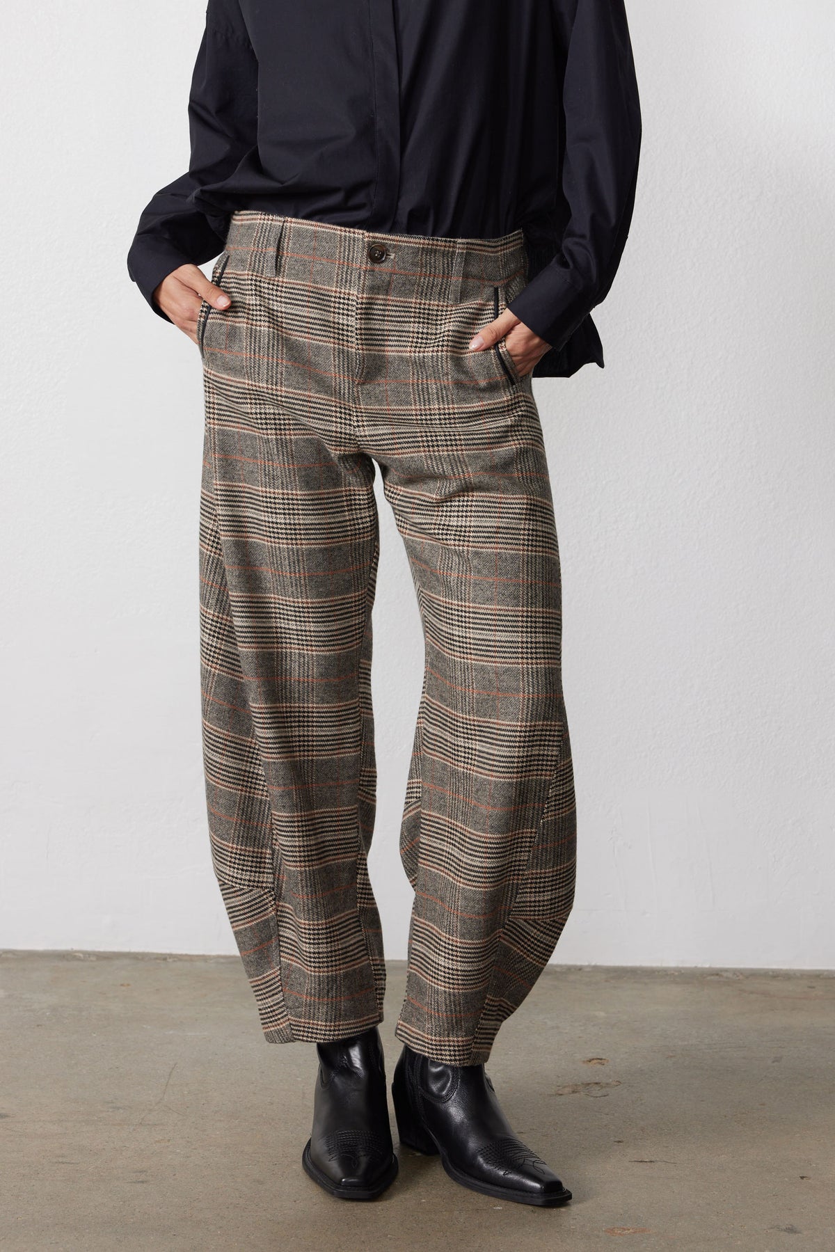 Brown plaid trousers with button closure, belt loops, and relaxed barrel fit