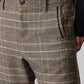 Brown plaid pants close-up: button waistband and textured woven fabric