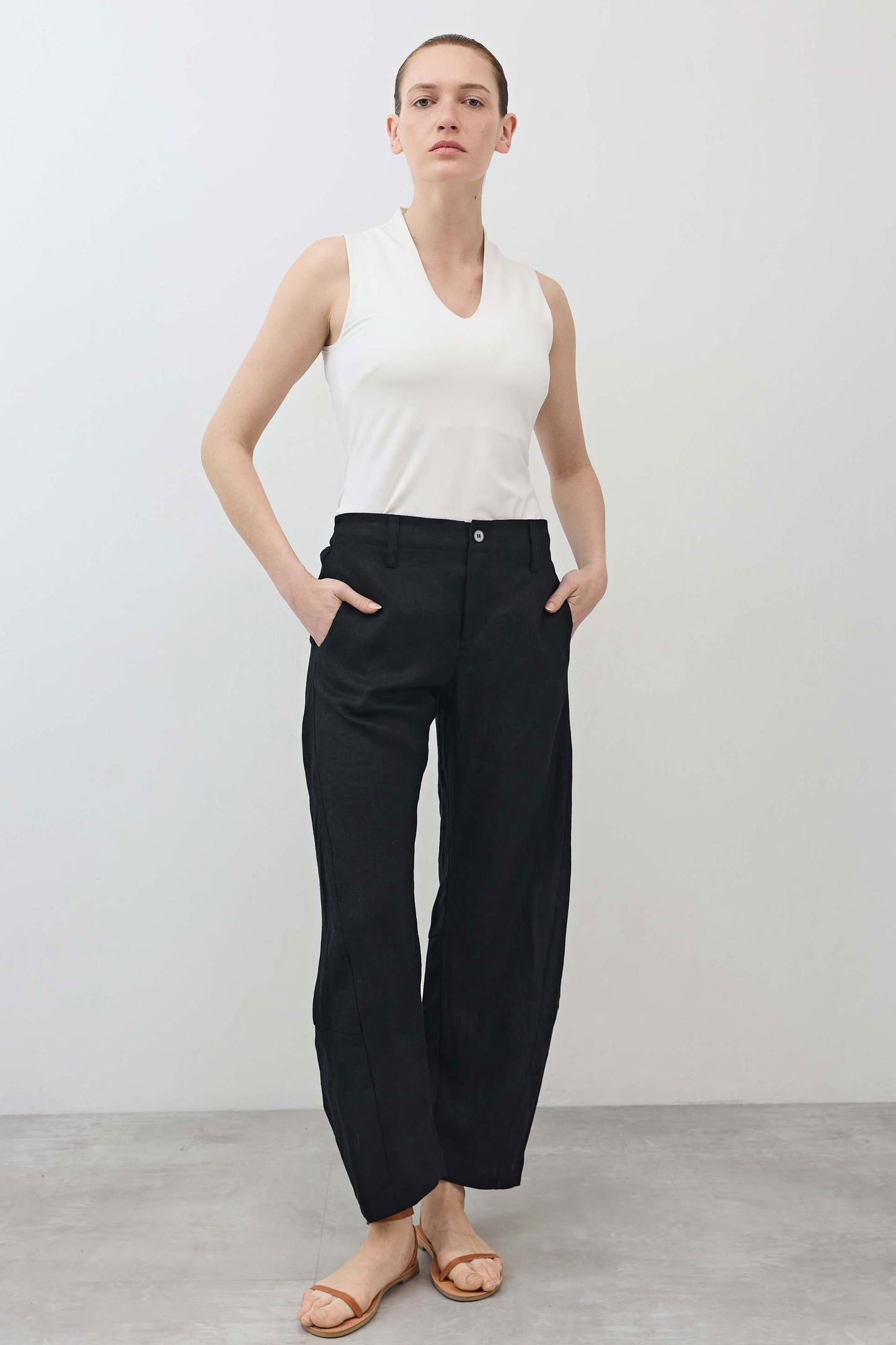 Black linen pants with wide leg drape, high waist with button closure, ankle length