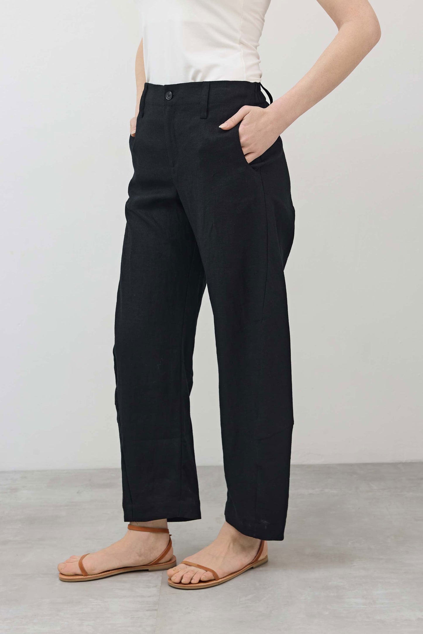 Black loose linen pants with relaxed fit, front pleats, full-length