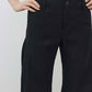 Black linen pants close-up: button waist, smooth front, relaxed drape and tapered legs